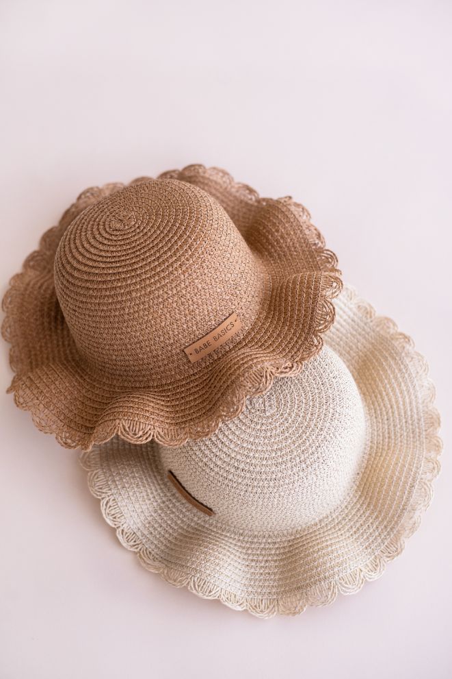 Two scalloped-brim baby straw sun hats stacked, the Natural tan shade over the Cream shade - Babe Basics